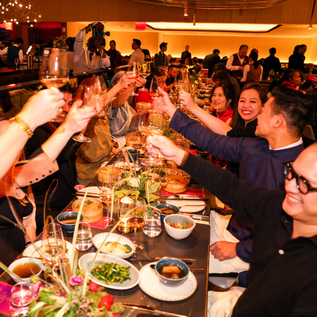 a group of people cheers-ing with wine glasses