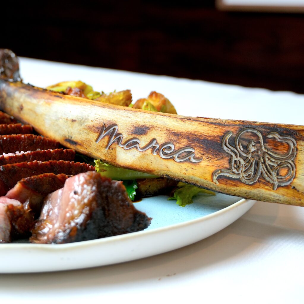 a tomahawk steak with a marea branded bone