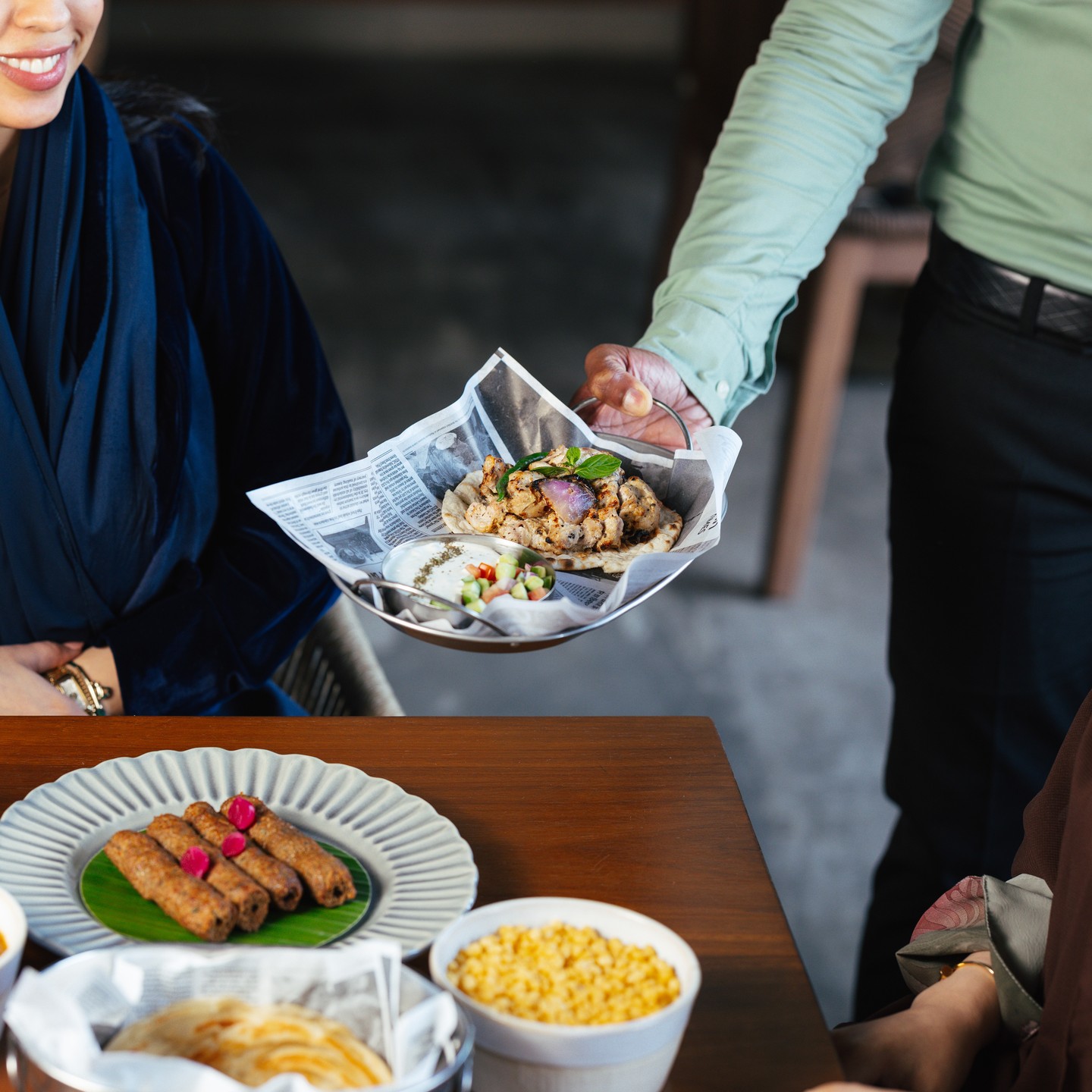 a dish being delivered to the table at mollaha saudia arabia